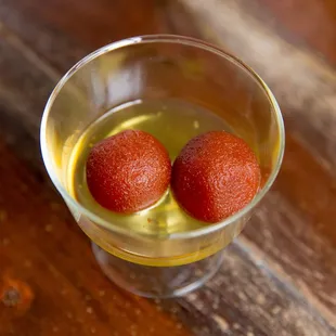 two gulabs in a glass of water