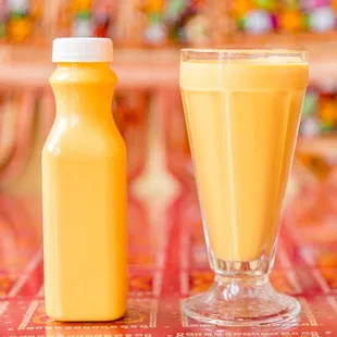a glass of orange juice and a bottle of orange juice