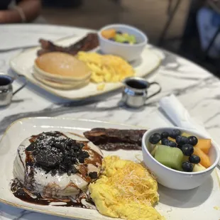 Oreo pancakes, scrambled eggs with cheese, fruit and maple brown bacon