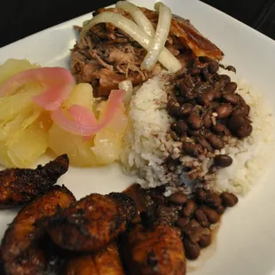 a plate of rice, beans, and meat