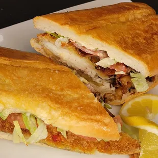 Fried fish sandwich with mayo mustard, lettuce tomato and bacon.  Only available on Fridays