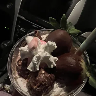 Two chocolate covered strawberries, two to three Ferrero Rocher chocolates