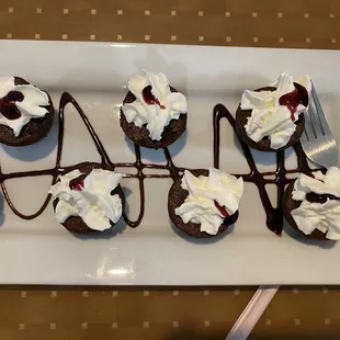 chocolate cupcakes with whipped cream and cherries