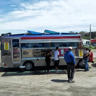 people getting food from the truck