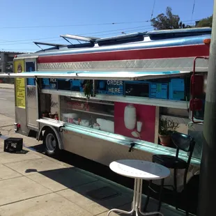 the food truck parked on the side of the road