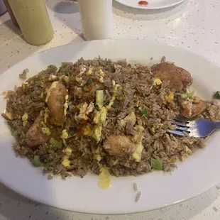 a plate of fried rice with meat and vegetables