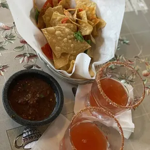 Chips and salsa with a Mexican Candy shooter.