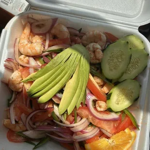 a salad in a styrofoam container