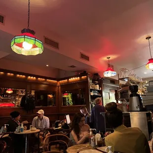 people sitting at tables in a restaurant