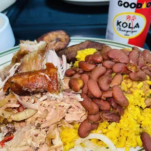 Roast pork with yellow rice, red beans, and boiled yuca