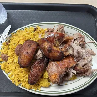 Yellow rice, plantains and shredded/fried pork