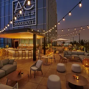 a patio with seating and lights