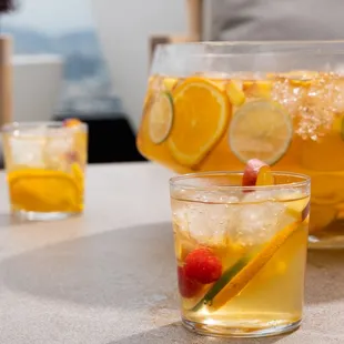 a pitcher of lemonade and two glasses of lemonade