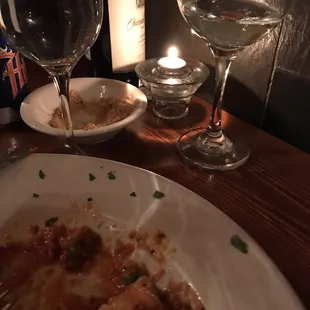 a plate of pasta and wine glasses