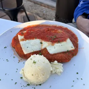 Chicken parm served with mashed potatoes