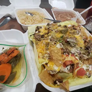 Carne Asada nachos with extra cheese, sides of rice and beans, side of carrots, and vampirr juice. Fantastic!