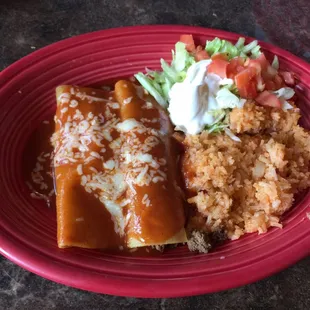 a plate of enchiladas and rice