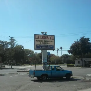 a blue pick up truck parked in a parking lot