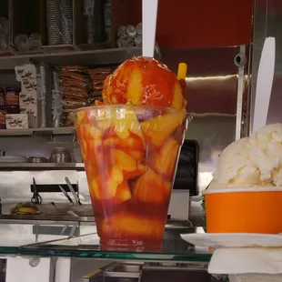 a glass of ice cream and a bowl of fruit
