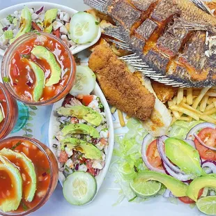 a plate of fish, salad, and fries