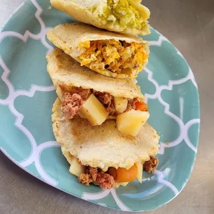 three tacos stacked on a plate