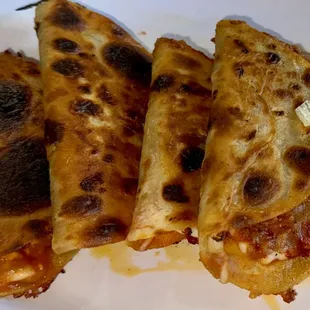 three quesadillas on a plate