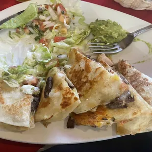 Chicken and steak quesadilla with pico de gallo, sour cream, and guacamole.