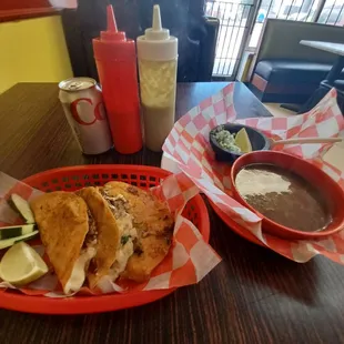 Birria tacos with consume' and sauces.