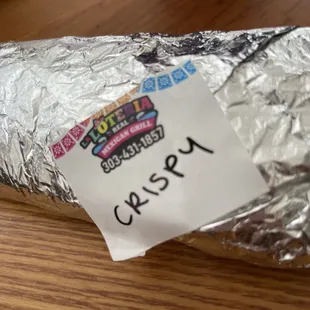 a burrito wrapped in aluminum foil