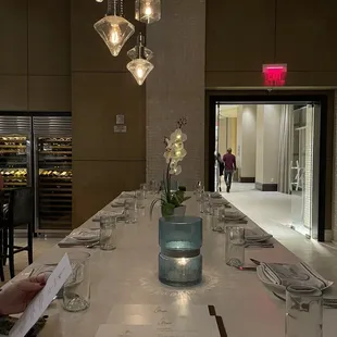a long dining table with place settings