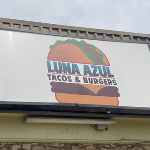 a sign for a taco and burgers restaurant