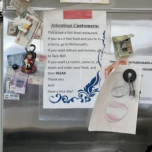 a sign posted on a refrigerator