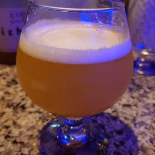 a glass of beer on a counter