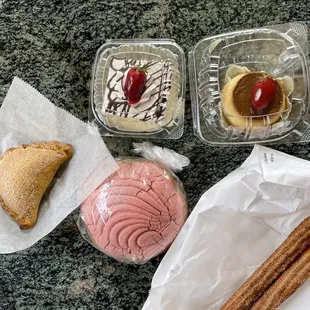 Top row (left to right): tres leches cake, flan Bottom row (left to right): rice pudding empanada, cinnamon concha bread, churros
