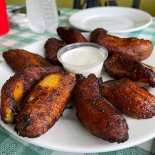 a plate of chicken wings with dipping sauce