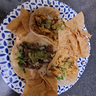 Three tacos, 2 chicken, 1 steak and rice and beans. Chips too!