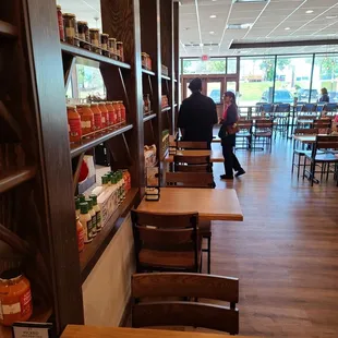 the inside of a restaurant with tables and chairs