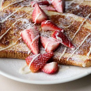 a plate of french toast with strawberries