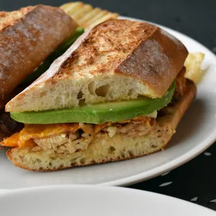 a sandwich on a plate with potato chips
