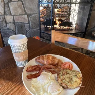 a plate of breakfast food and a cup of coffee