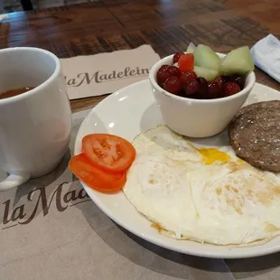 American breakfast with over medium eggs, sausage and fruit!! Very good!