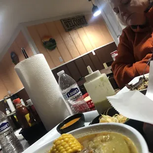 a woman sitting at a table with a plate of food