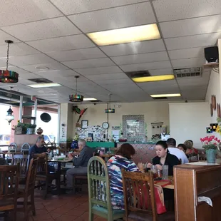 people sitting at tables in a restaurant