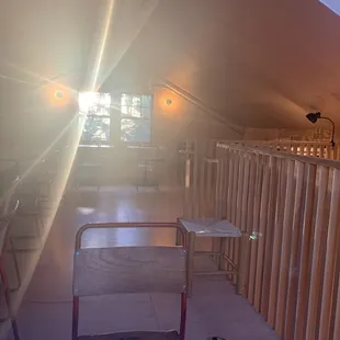 a room with a ladder and a bed