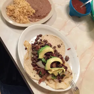 two plates of mexican food on a table