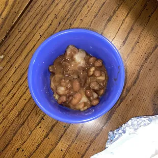 a bowl of beans and a hot dog