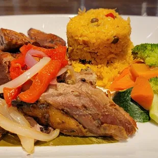 Pernil with yellow rice and plaintains.