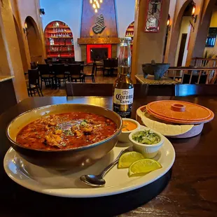 a bowl of soup and a plate of tortillas