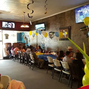 people sitting at tables in a restaurant