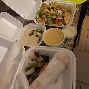 Shish tawook sandwich with veggies; baba ghanoush; chicken lemon soup; small garlic; fattoush salad.